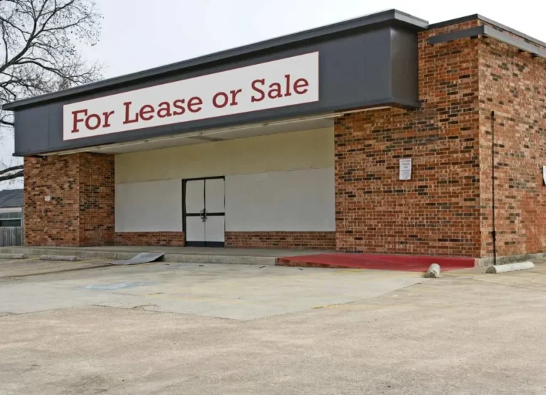 Building that looks closed with For Lease or Sale on the top